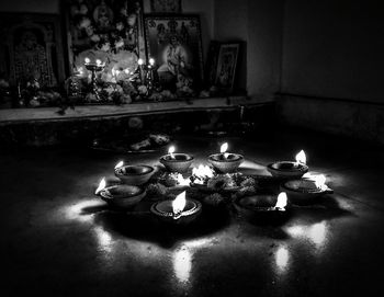 Lit candles on table at home