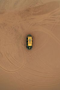 High angle view of tire tracks on desert