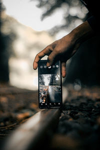 Close-up of hand holding camera