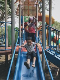 Children playing on slide at playground