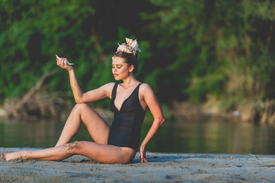 Full length of young woman in lake