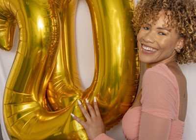 Portrait of smiling woman holding camera