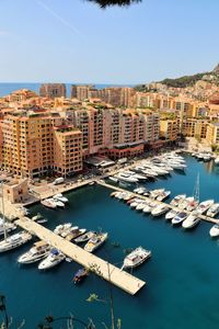 High angle view of buildings by sea against sky