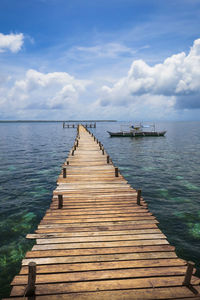 Pier over sea against sky