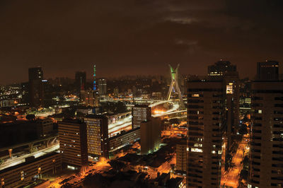 High angle view of illuminated buildings in city at night