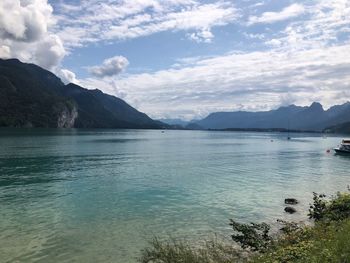 Scenic view of sea and mountains against sky