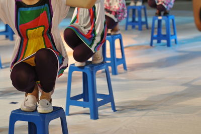 Low section of women performing on stools
