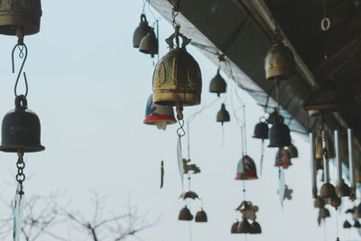 Low angle view of lanterns hanging against sky