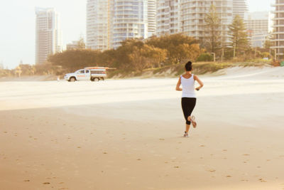 Full length of man skateboarding in city