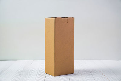 Close-up of box on table against white background