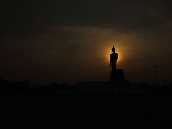 Silhouette statue against sky during sunset