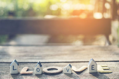 Close-up of love text on model homes at table