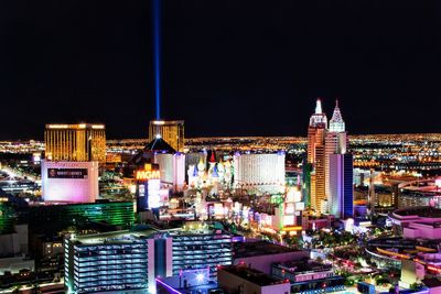 High angle view of illuminated buildings against sky at night