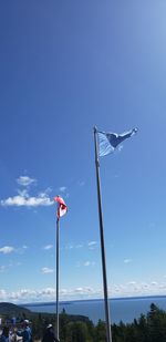 Low angle view of crane against blue sky