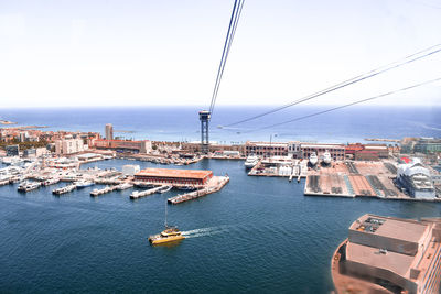 High angle view of sea by buildings against sky