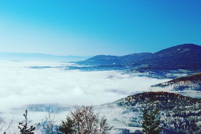 Scenic view of snowcapped mountains against blue sky