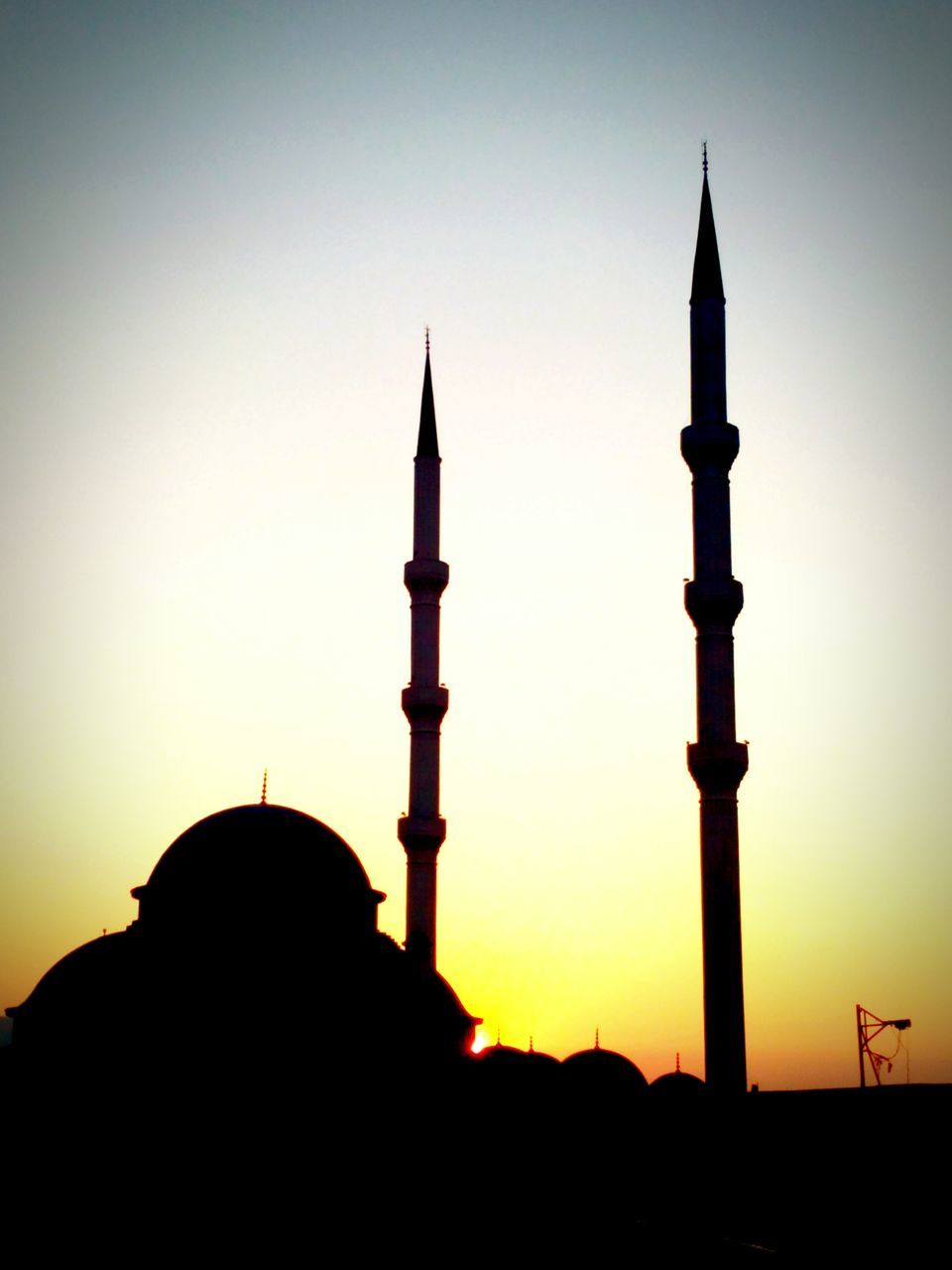 clear sky, silhouette, religion, built structure, sunset, architecture, building exterior, copy space, tower, low angle view, mosque, islam, lighthouse, dome, travel destinations, protection, famous place, place of worship, spirituality