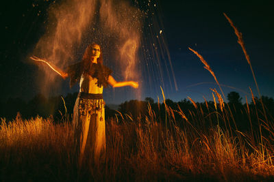 Woman in halloween witch costume throws the ashes of the dead.