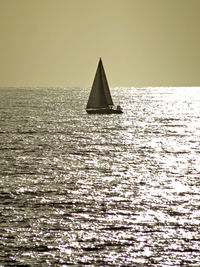 Sailboat on sea against clear sky