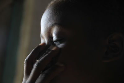 Close-up of woman covering mouth with hand