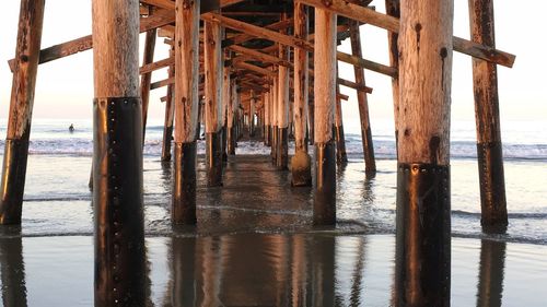 Silhouette pier on sea against sky