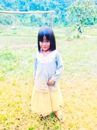 Portrait of cute girl standing on land