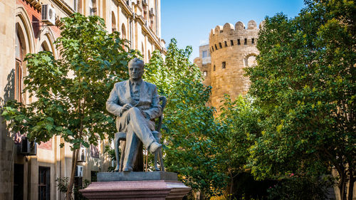 Low angle view of statue against trees