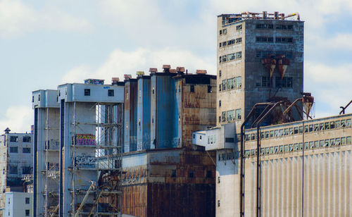 Low angle view of factory against sky