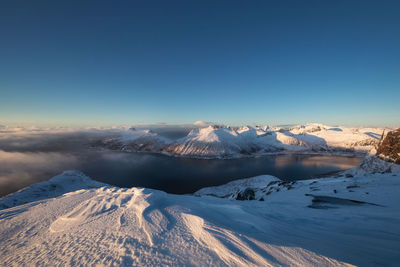 Aerial view of snowcapped mountains against sky