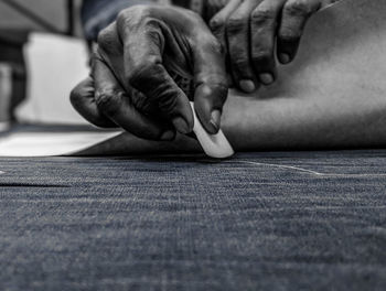 Low section of man sitting on floor