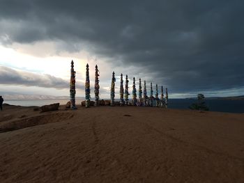 Scenic view of beach against sky at dusk