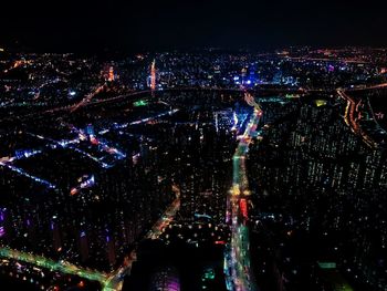 High angle view of city lit up at night