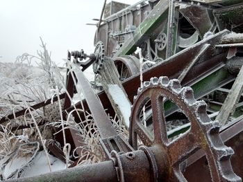 Close-up of abandoned wheel against sky