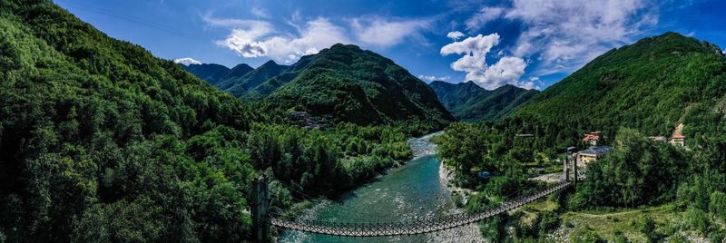 Panoramic view of trees and mountains against sky