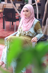 Young woman sitting on chair