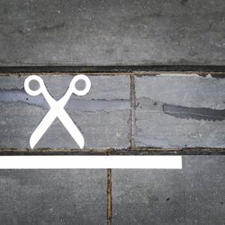 High angle view of scissors sign on footpath