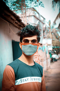 Portrait of young man wearing sunglasses standing outdoors