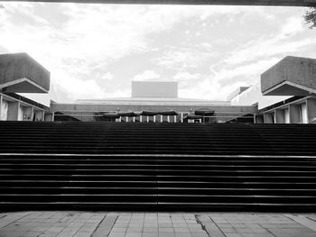 Low angle view of staircase in city against sky