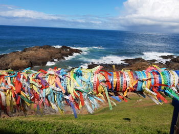 Graffiti on beach against sky