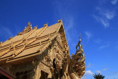 Low angle view of statue against blue sky