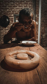 Portrait of shirtless man holding coffee at home