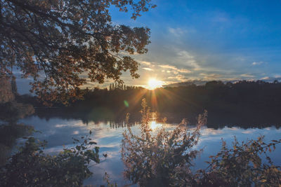 Scenic view of lake against sky during sunset