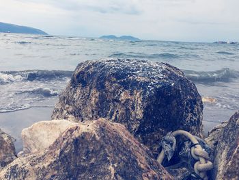 Rocks on shore against sky