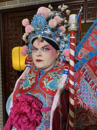 Portrait of woman standing against the wall
