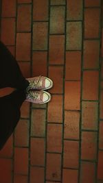 Low section of woman standing on tiled floor