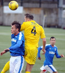 People playing soccer ball on field