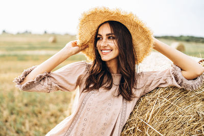 Portrait of smiling young woman on field