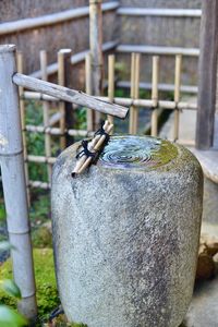 Close-up of metal railing on wooden post