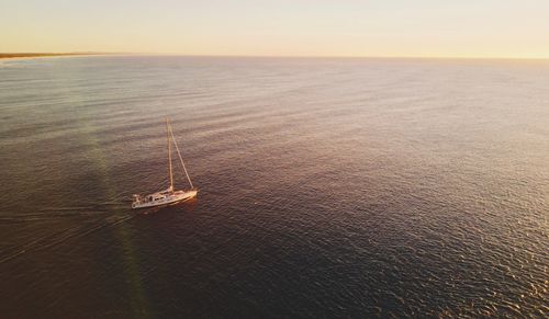 High angle view of sailboat sailing in sea against sky