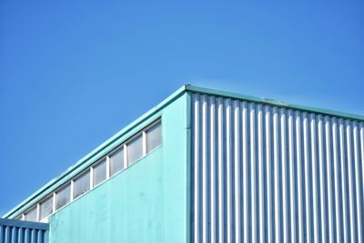 Low angle view of building against clear blue sky